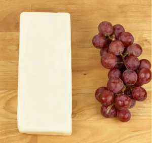 Aged Havarti cheese with red grapes