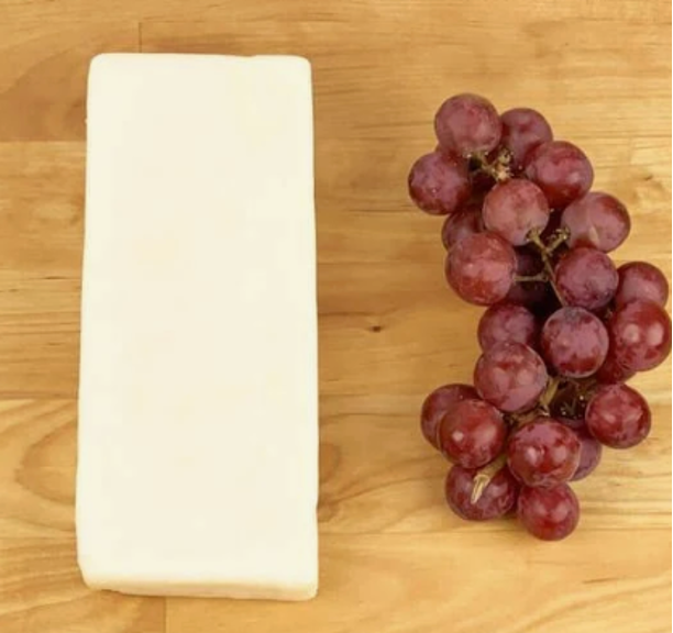 Aged Havarti cheese with red grapes